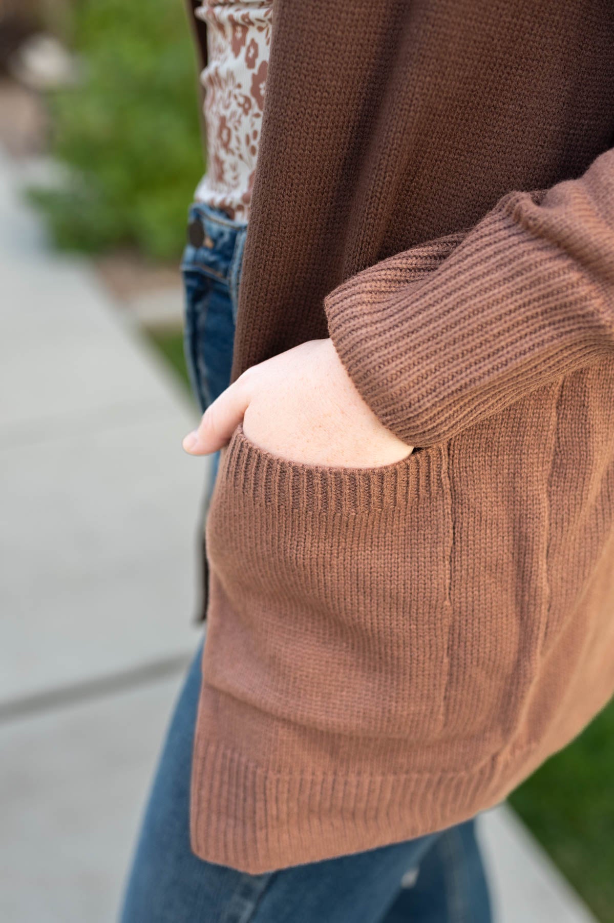View of the pocket on a chocolate cardigan