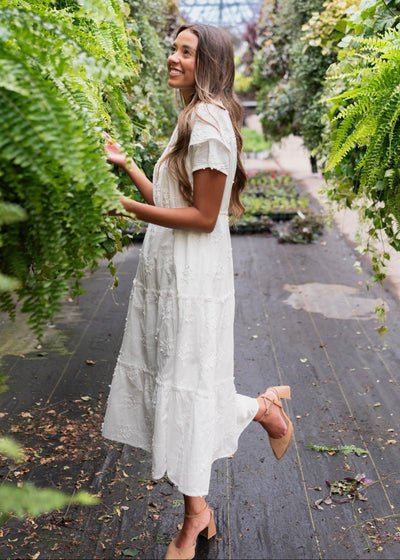 Side view of the white floral embroidered dress with short sleeves
