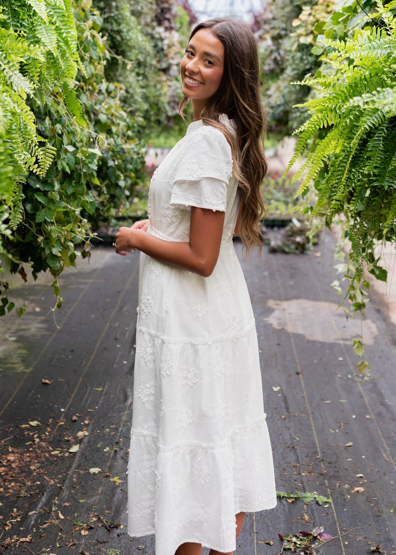Side view of a white floral embroidered dress