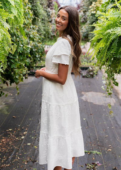 Side view of a white floral embroidered dress