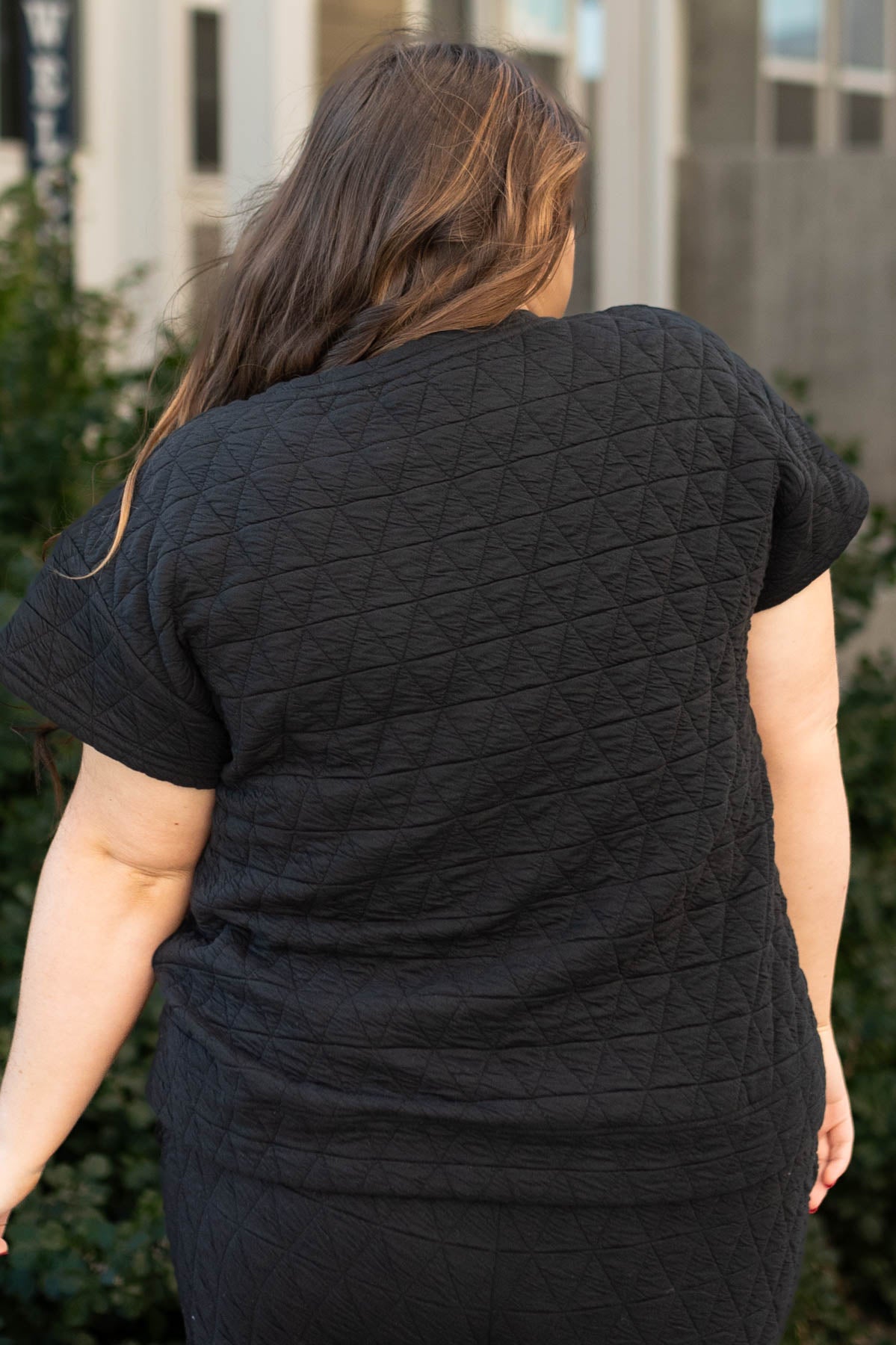 Back view of a plus size black top