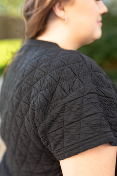 Fabric view of a plus size quilted black top