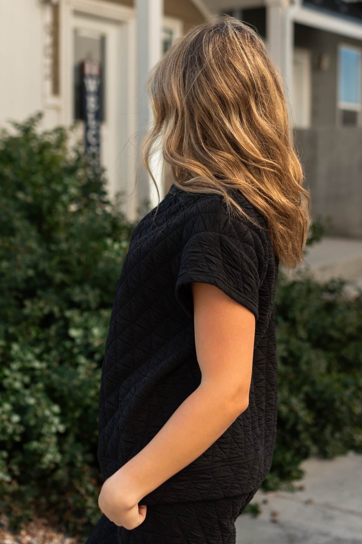 Side view of a quilted black top