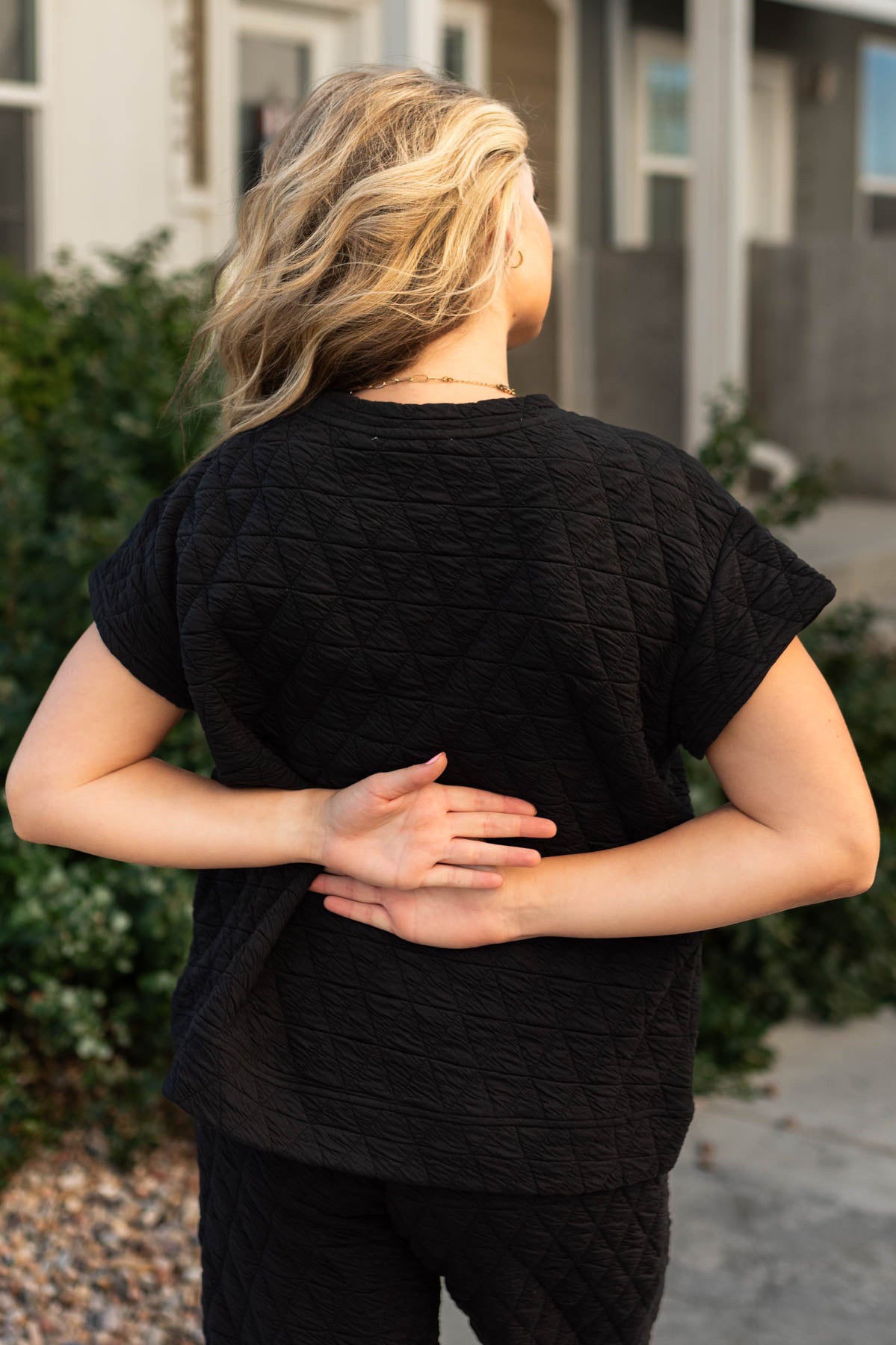 Back view of a quilted black top