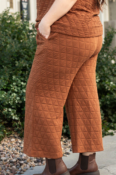 Side view of plus size cinnamon pants