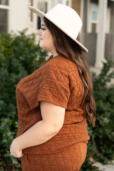 Side view of a plus size cinnamon top
