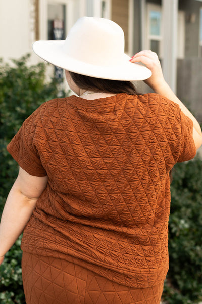 Back view of a plus size cinnamon top