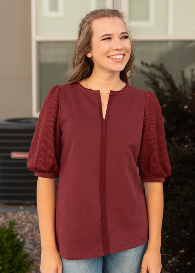 Short sleeve burgundy top with a seam down the center