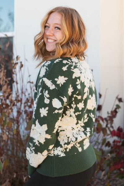 Side view of a green floral sweater