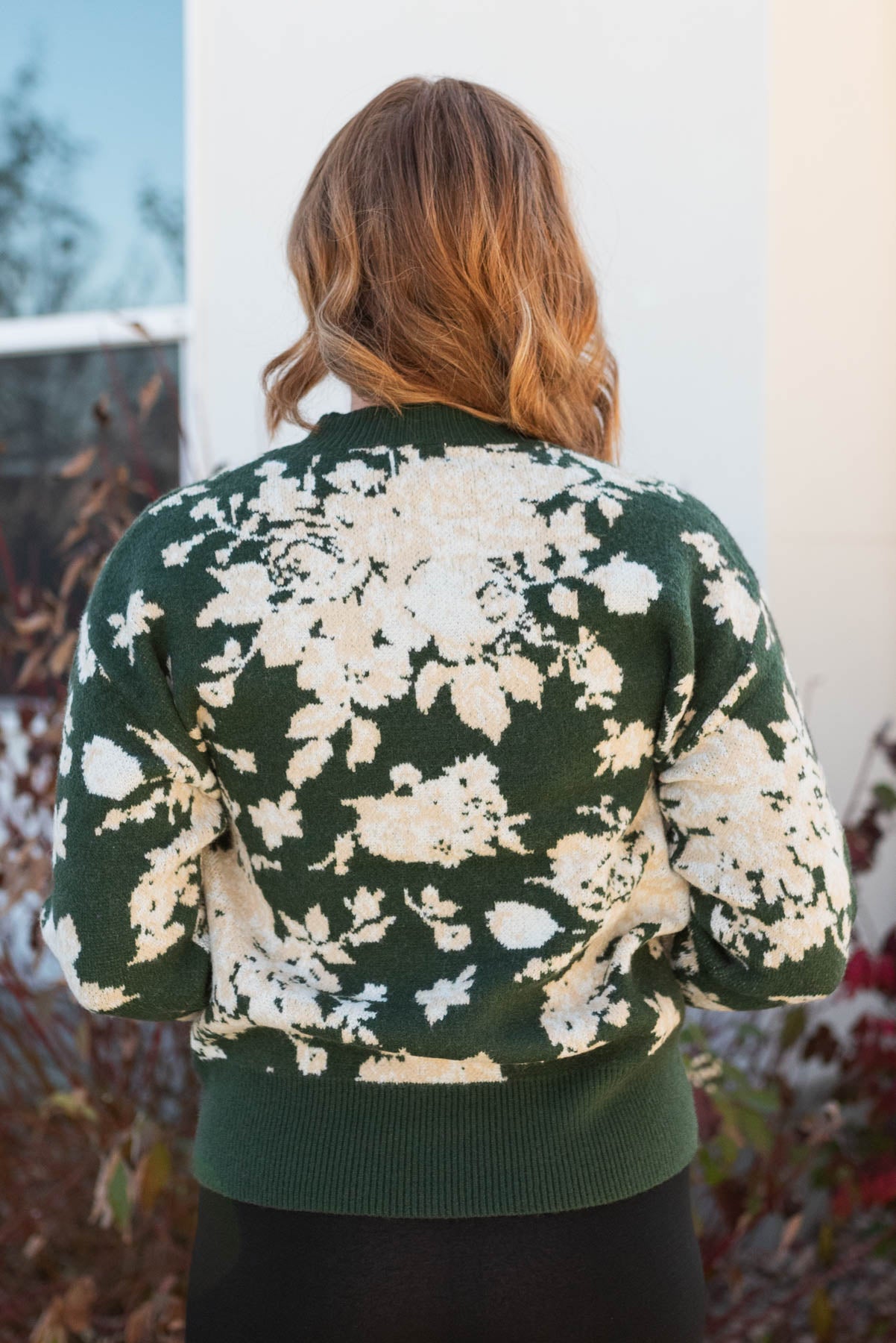 Back view of a green floral sweater