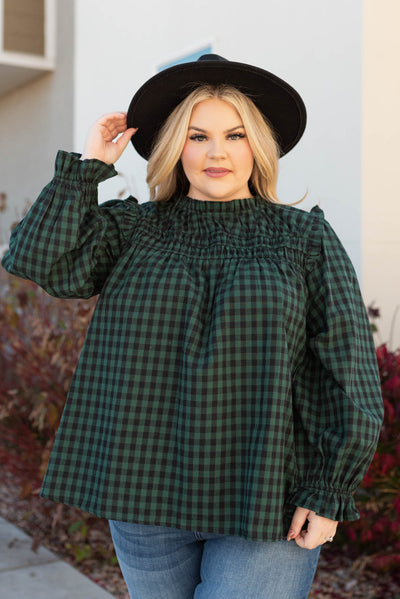 Plus size hunter green ruffle blouse with smocking at the neck