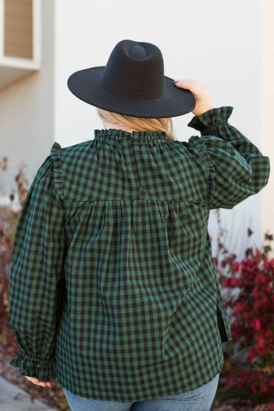 Back view of a plus size hunter green ruffle blouse