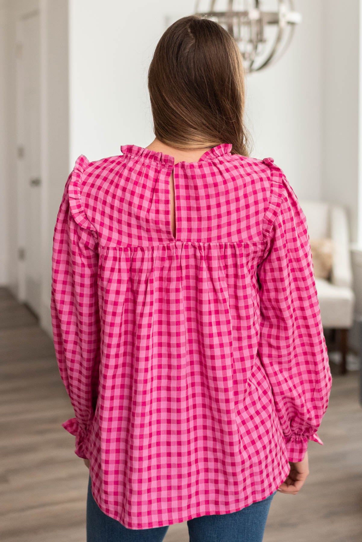 Back view of the pink fuchsia ruffle blouse with back closer