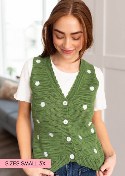 Green sweater vest with white buttons and small white flowers