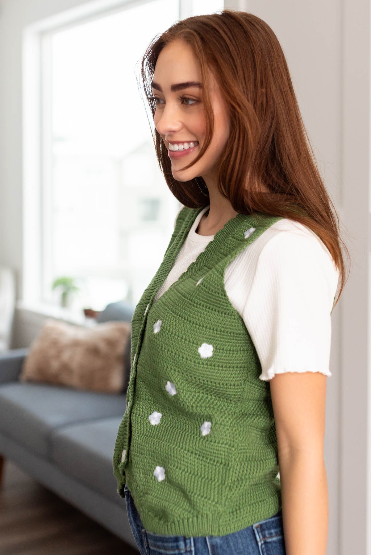 Side view of the green knitted sweater vest