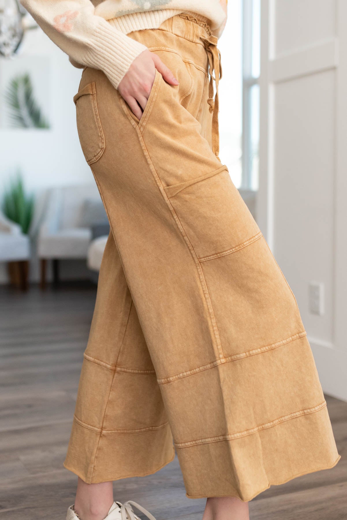 Side view of camel pants with pockets