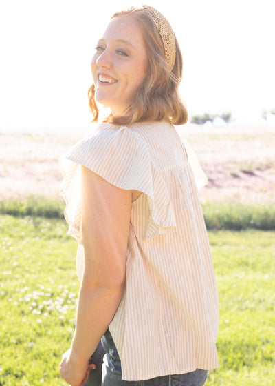 Side view of a taupe top
