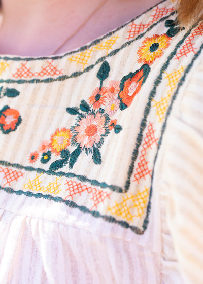 Embroidery of a taupe top
