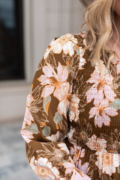Close up of the fabric on a brown floral dress