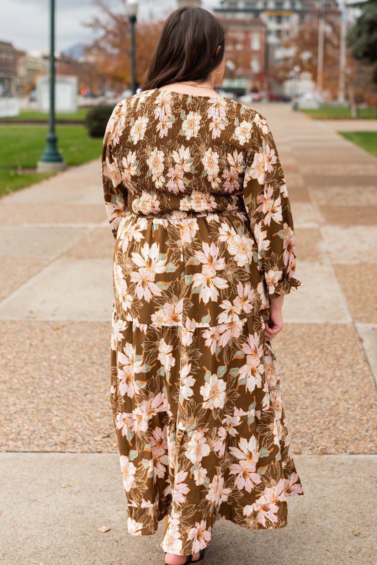 Back view of a plus size brown floral dress