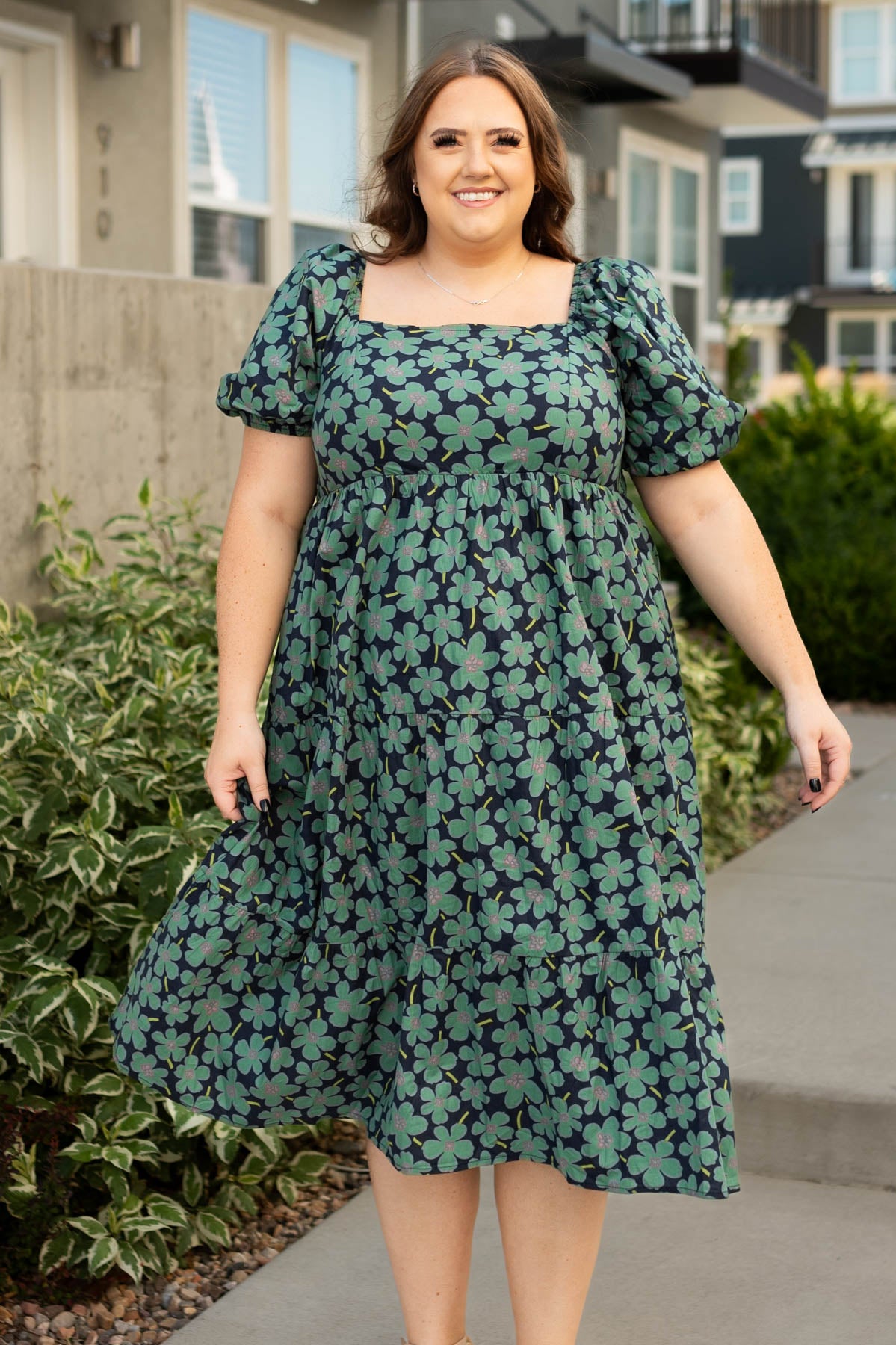 Front view of a plus size dark green dress with a square neck