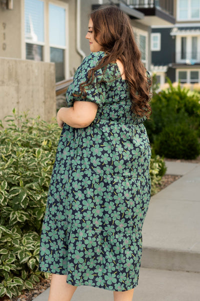 Side view of a plus size dark green dress
