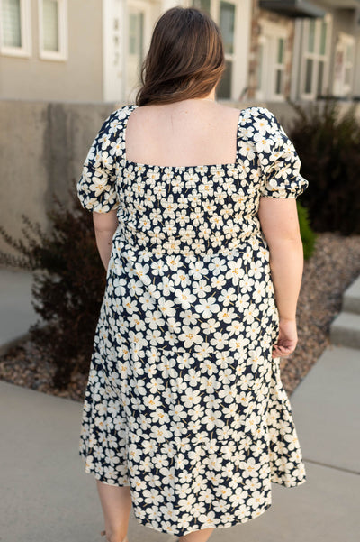 Back view of a plus size ivory dress with floral print