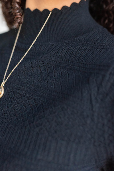 Close up of the black pattern sweater with turtle neck
