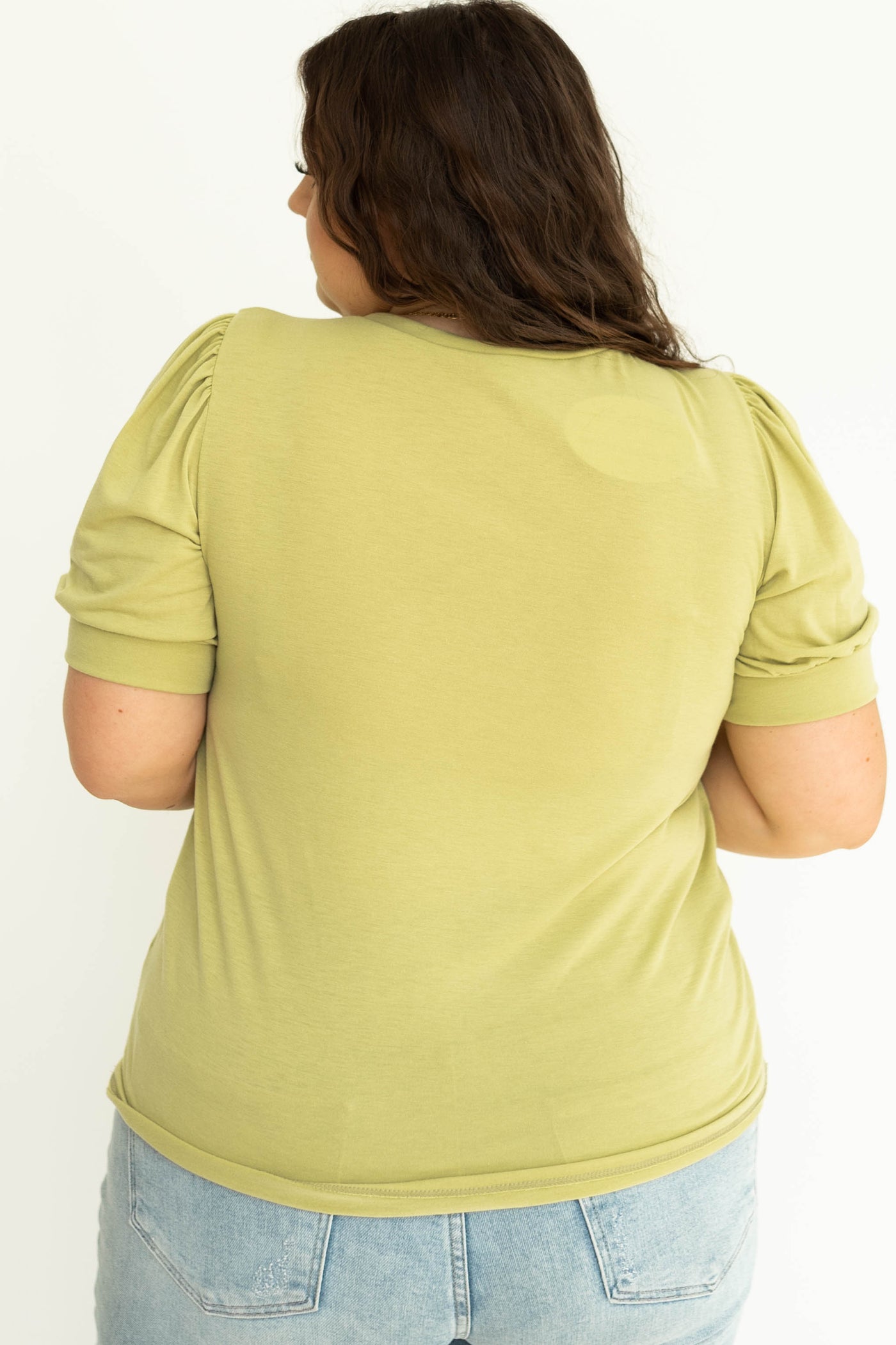 Back view of a plus size kiwi colored knit top.