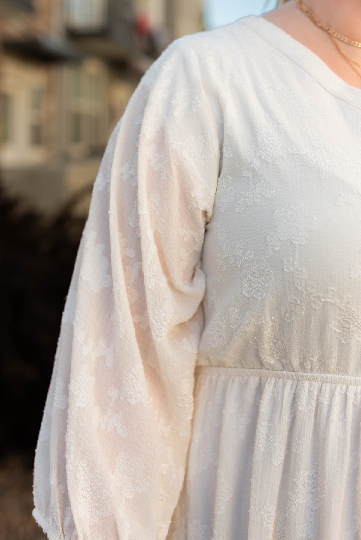 Close up of a plus size cream dress