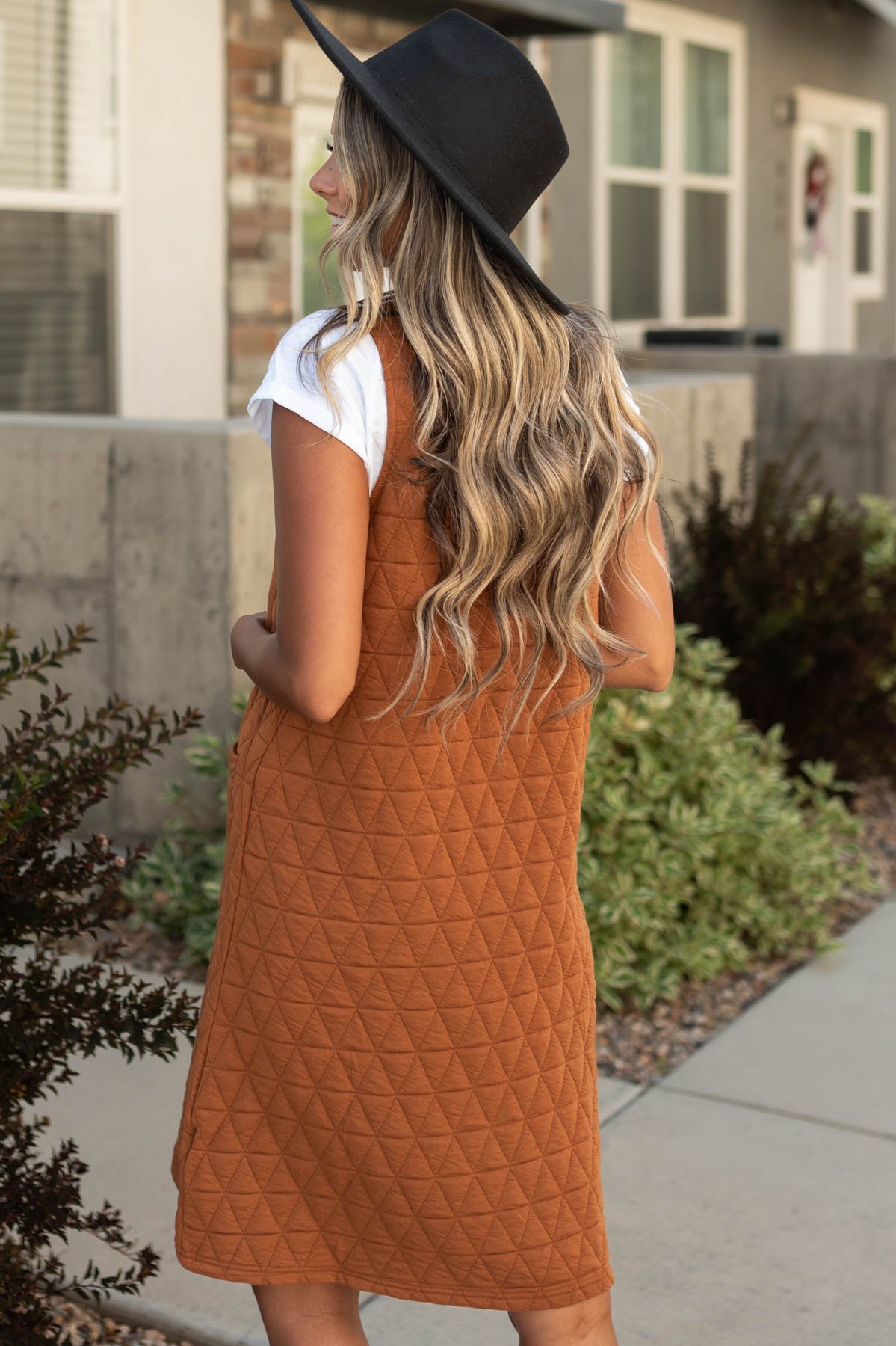 Back view of a cinnamon dress with quilted fabric