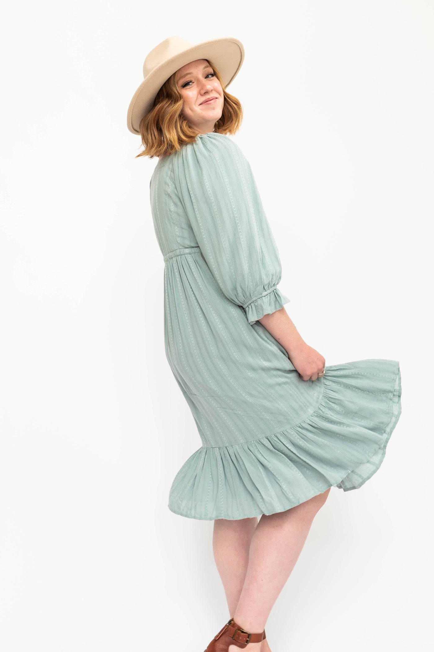 Side view of a vintage seafoam green dress with 3/4 sleeve.