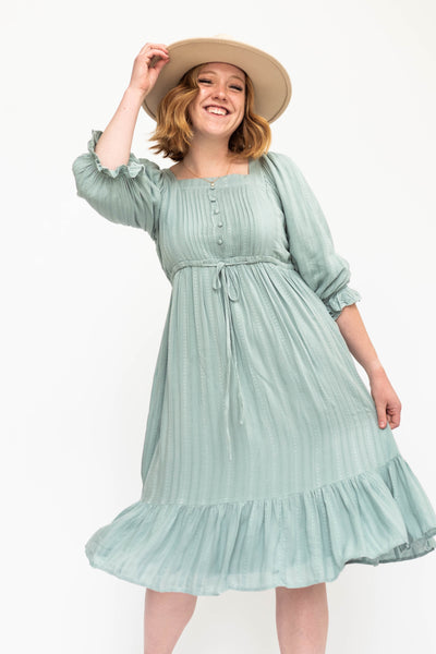 Seafoam green dress with 3/4 sleeves and a pleated bodice.