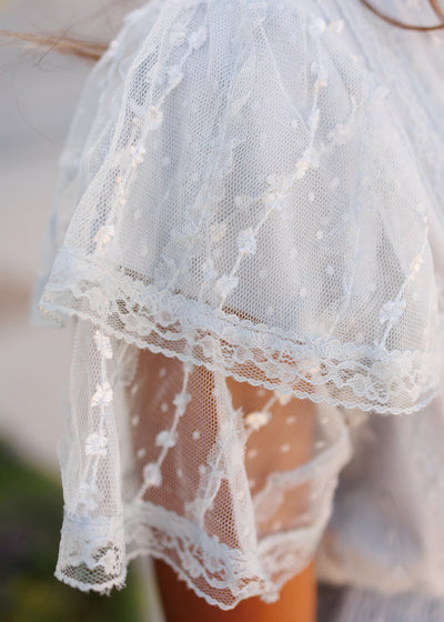 Close up of the fabric and sleeve on the dusty blue lace dress