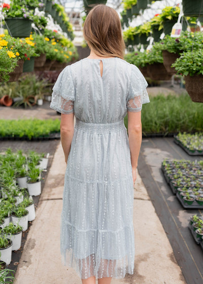 Back view of the dusty blue lace dress