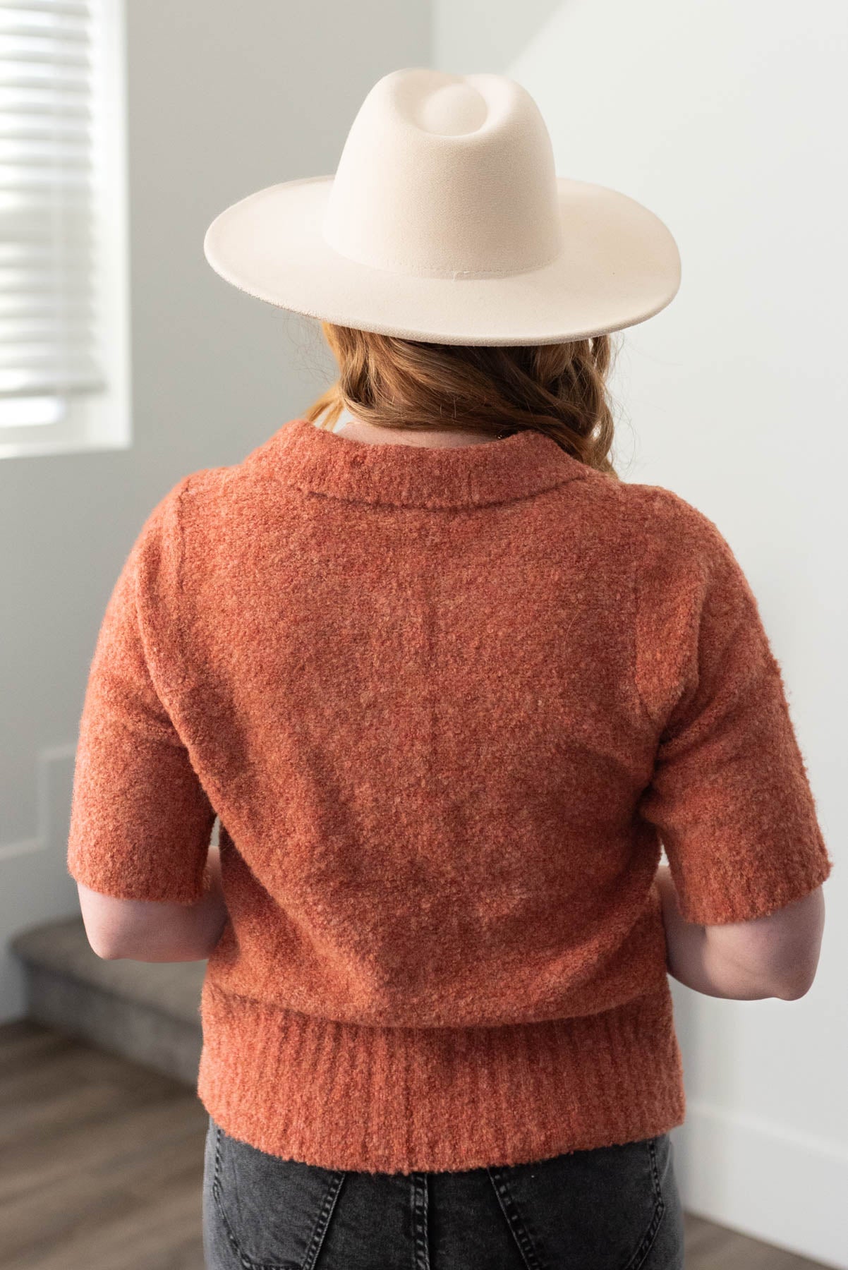 Back view of a terracotta knit sweater