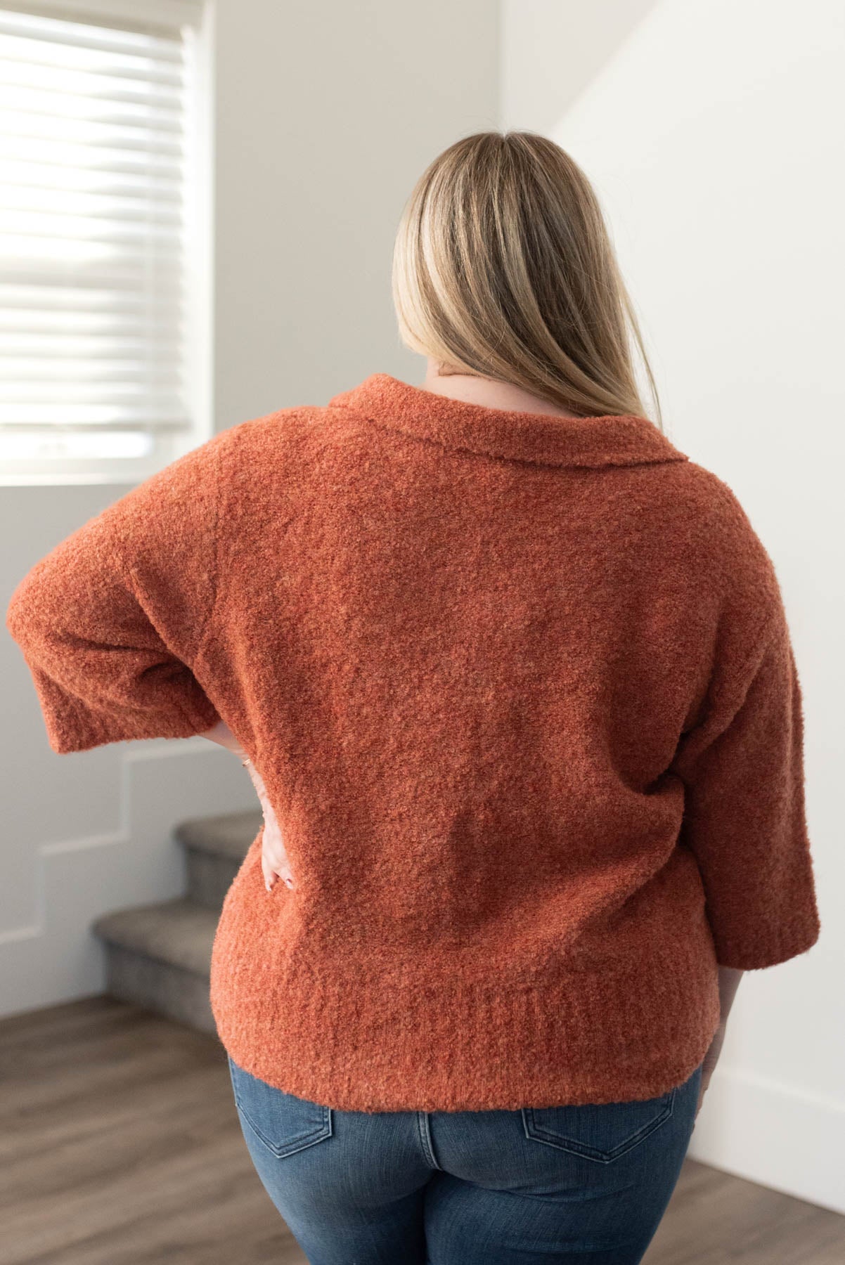 Back view of a plus size terracotta knit sweater
