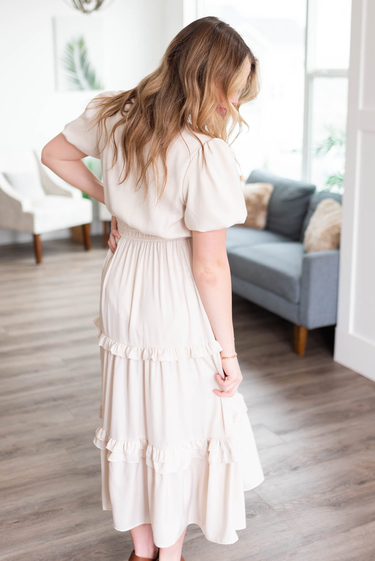 Side view of the ivory satin ruffle dress