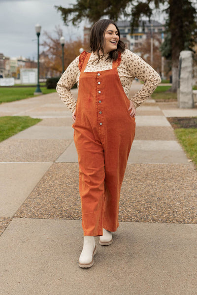 Plus size rust jumpsuit with ruffles on the straps