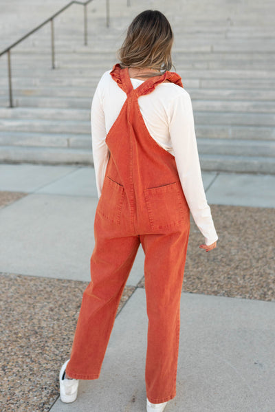 Back view of the rust jumpsuit with back pockets