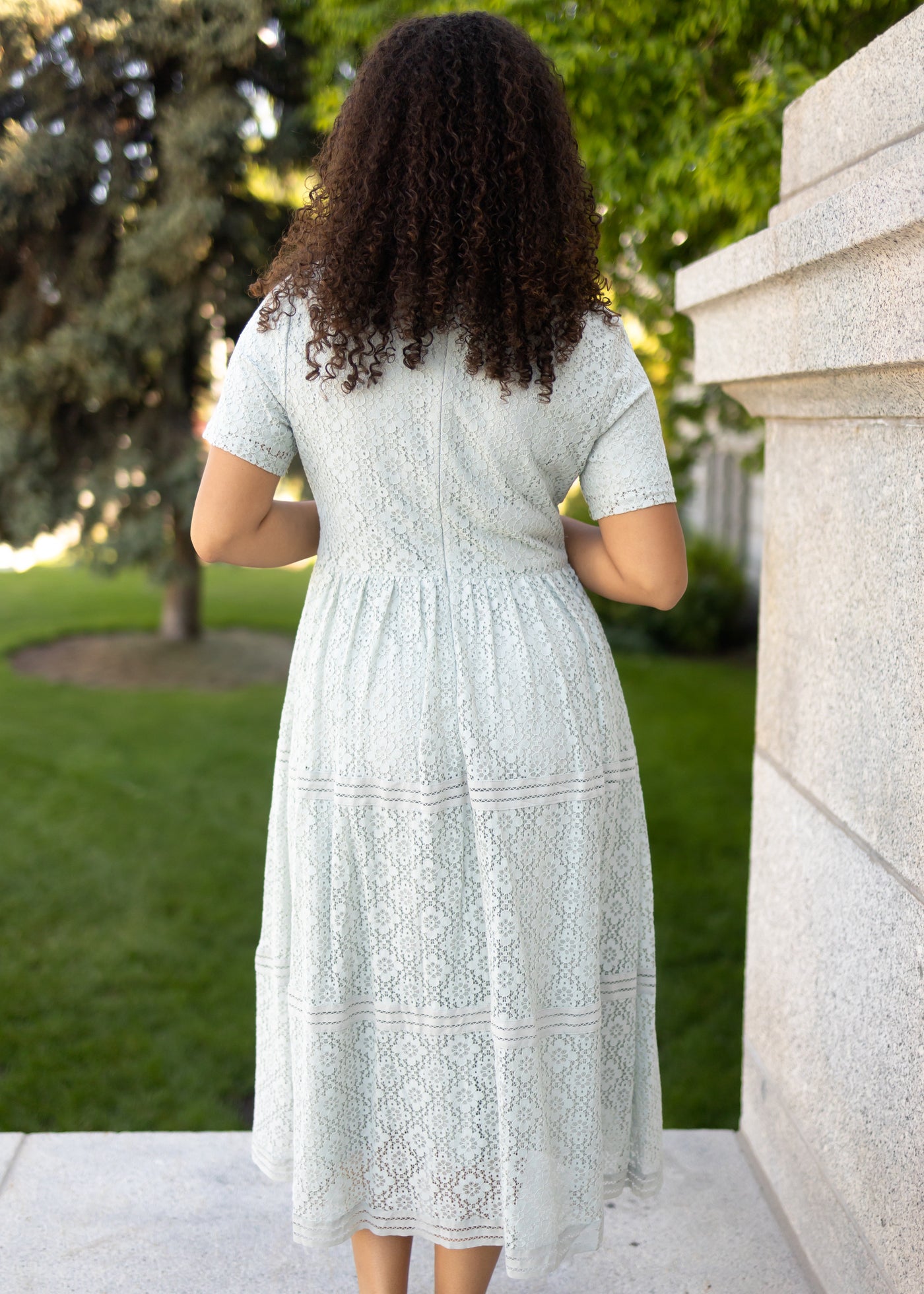 Back view of a dusty sage dress with short sleeves