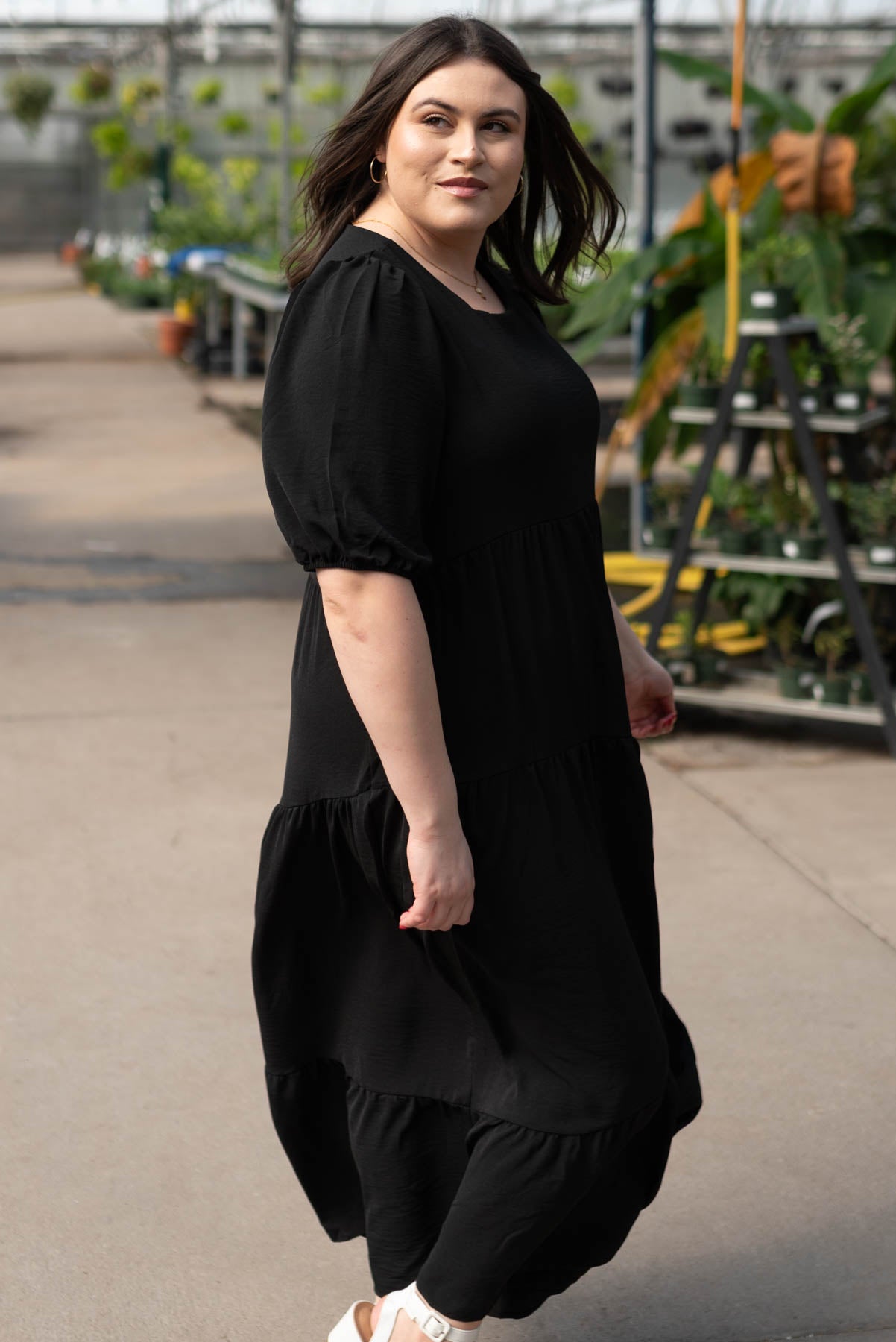 Side view of the plus size black tiered dress