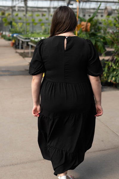 Back view of the plus size black tiered dress