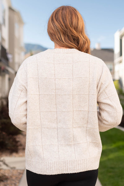 Back of a oatmeal sweater