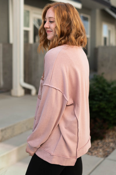 Side view of the Shania wood rose pullover top