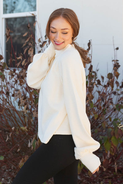 Side view of the cream textured sweater