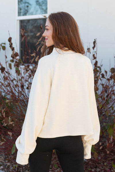 Back view of the cream texture sweater