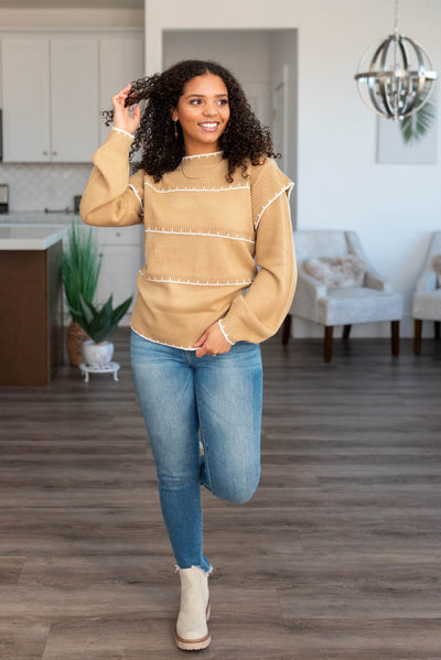 Front view of the taupe sweater with white stripes