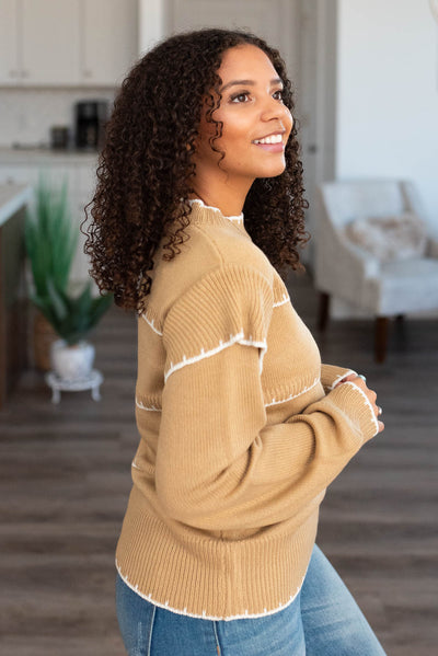Side view of the taupe stripe sweater