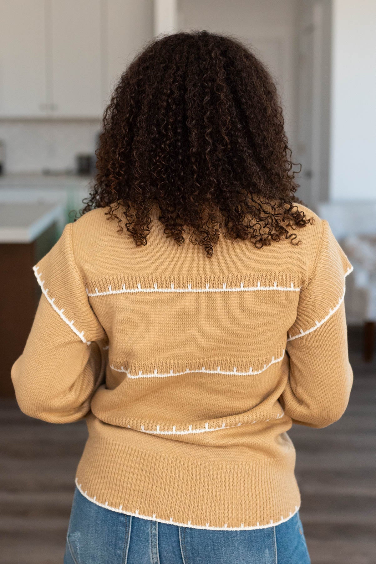 Back view of the taupe stripe sweater with long sleeves